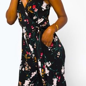 Black floral jumpsuit with adjustable straps, pockets and belt.